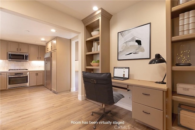 office with built in desk, recessed lighting, and light wood-type flooring
