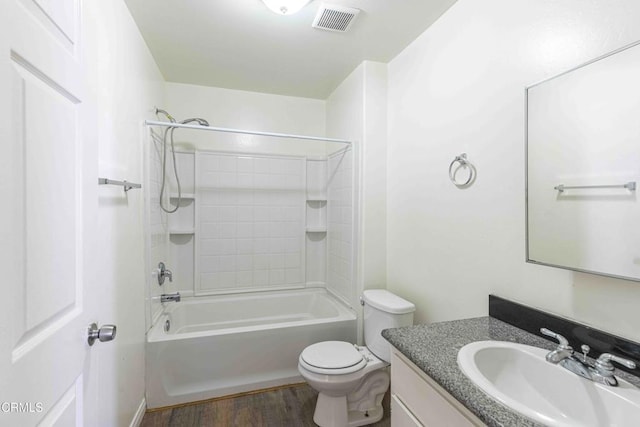 full bath with visible vents, toilet, vanity, shower / tub combination, and wood finished floors