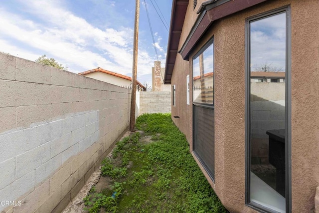 view of property exterior with a fenced backyard and stucco siding