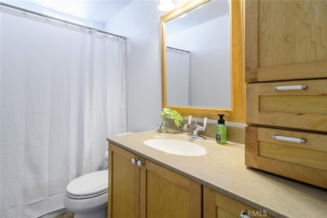 full bath featuring toilet, a shower with shower curtain, and vanity