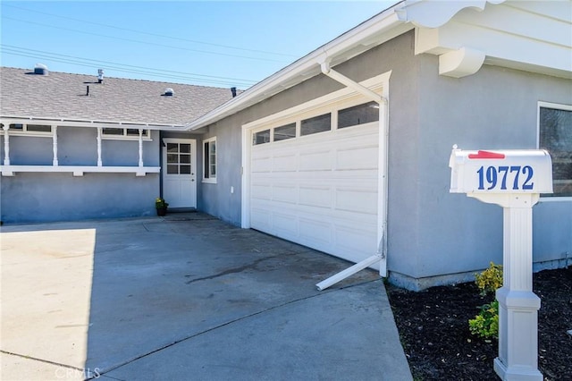 view of property exterior with an attached garage, roof with shingles, concrete driveway, and stucco siding