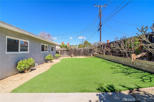 view of yard with a fenced backyard