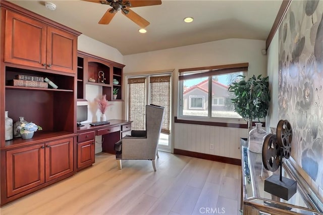 office space featuring built in study area, vaulted ceiling, light wood-style floors, and ceiling fan