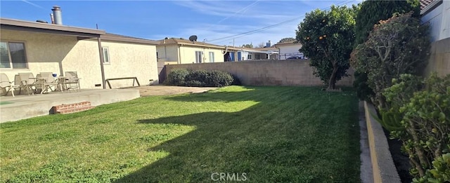 view of yard with fence and a patio