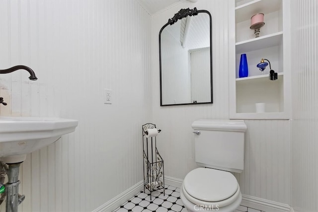 bathroom with tile patterned floors, toilet, and baseboards