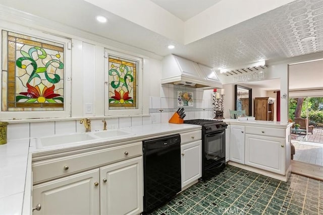 kitchen with black appliances, premium range hood, light countertops, and a sink