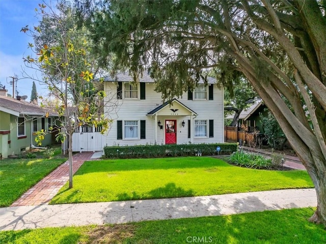 colonial house with fence and a front yard