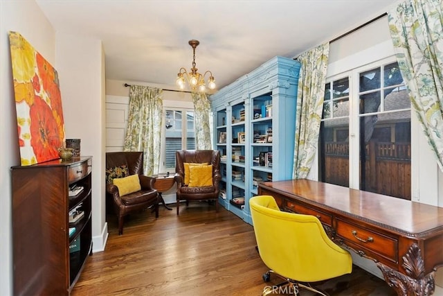 home office featuring an inviting chandelier and wood finished floors