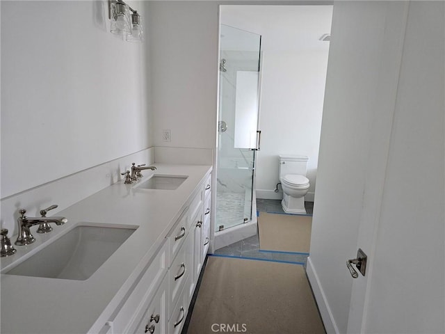 full bath featuring toilet, a shower stall, double vanity, and a sink