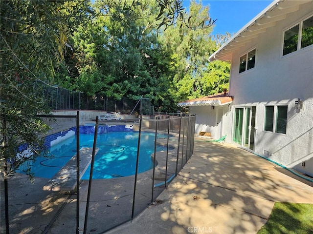 view of swimming pool with a fenced backyard, a fenced in pool, and a patio