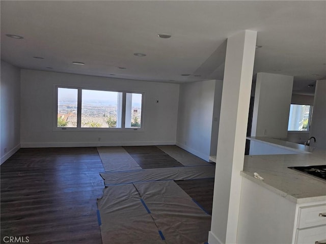 unfurnished room featuring dark wood-type flooring, recessed lighting, and baseboards