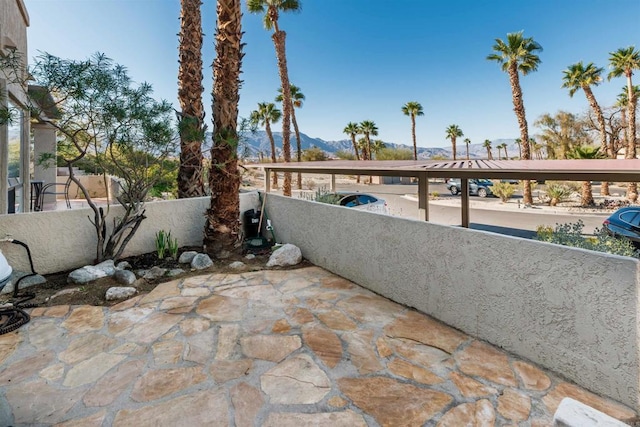 view of patio / terrace with fence private yard and a mountain view