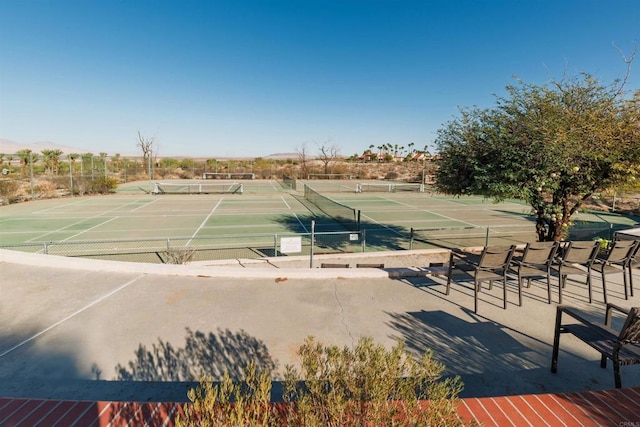 view of sport court featuring fence