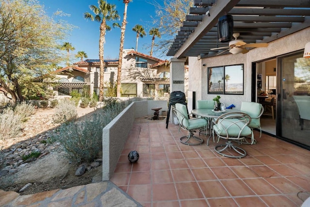 view of patio with outdoor dining area, fence, a pergola, and ceiling fan