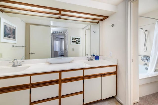 bathroom featuring double vanity, shower / tub combination, visible vents, and a sink