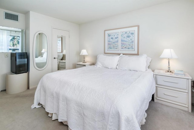 bedroom with light colored carpet and visible vents