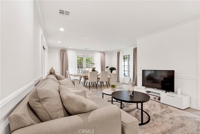 living area with ornamental molding, recessed lighting, visible vents, and baseboards