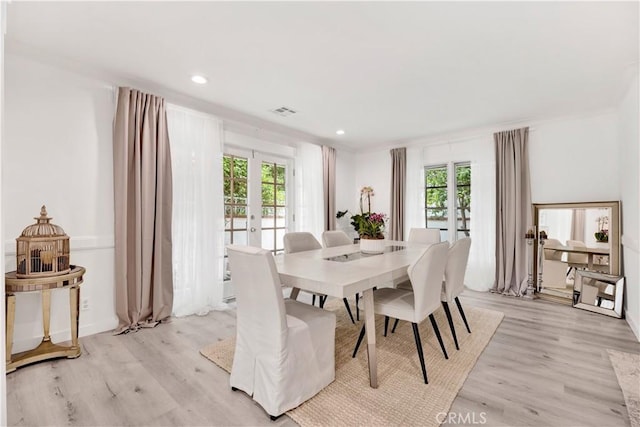 dining space featuring light wood-style floors, recessed lighting, visible vents, and french doors