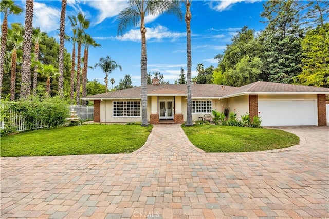 single story home featuring a garage, a chimney, fence, french doors, and stucco siding