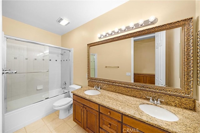 bathroom featuring tile patterned flooring, combined bath / shower with glass door, visible vents, and a sink