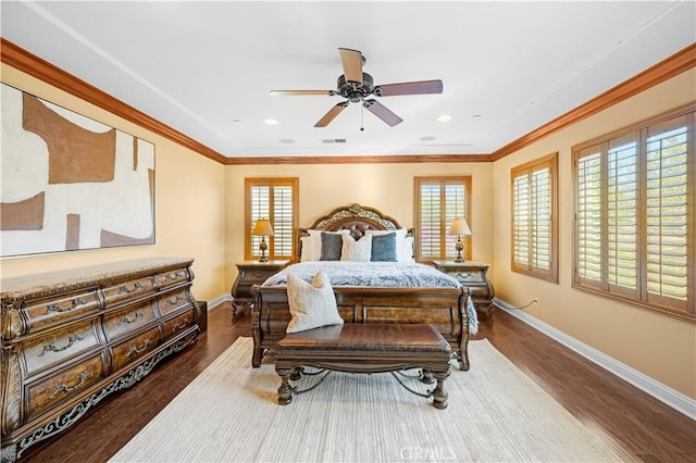 bedroom with crown molding, multiple windows, and wood finished floors