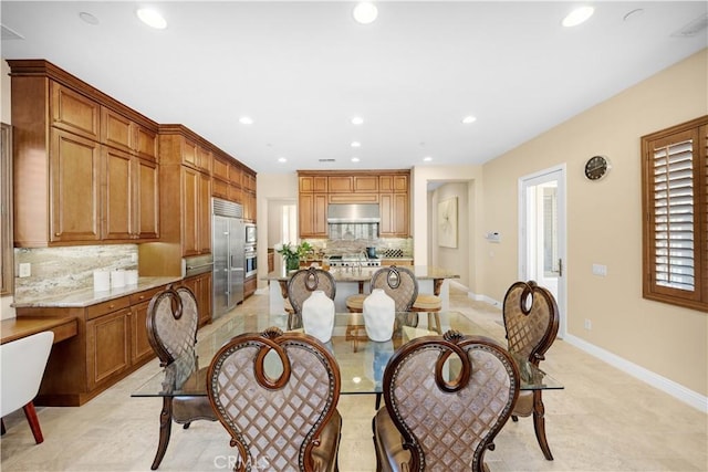 dining room with recessed lighting and baseboards