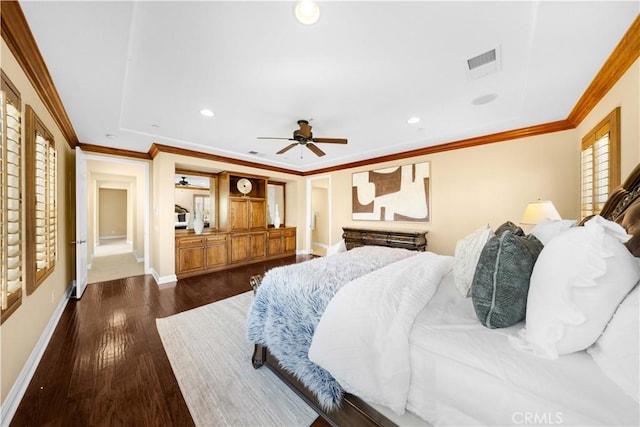 bedroom featuring wood finished floors, visible vents, baseboards, recessed lighting, and crown molding