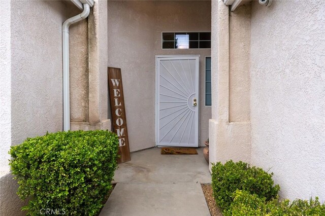 property entrance with stucco siding