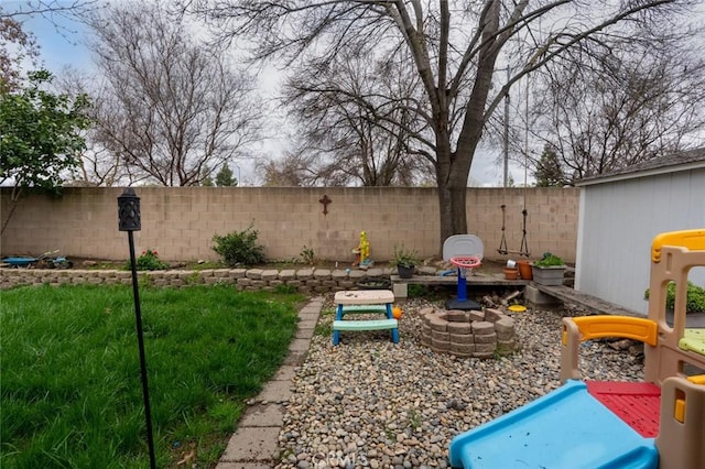 view of yard featuring a fenced backyard and a playground