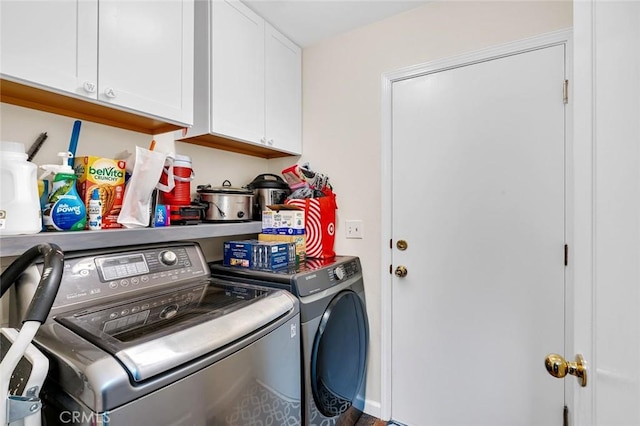 laundry area with cabinet space and washer and clothes dryer