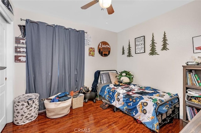 bedroom with a ceiling fan and wood finished floors