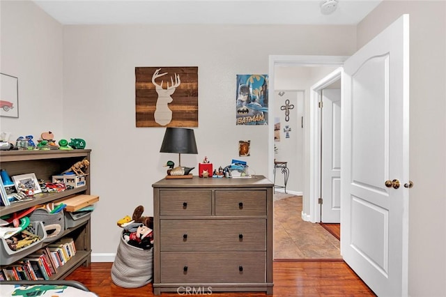 bedroom with light wood-type flooring and baseboards