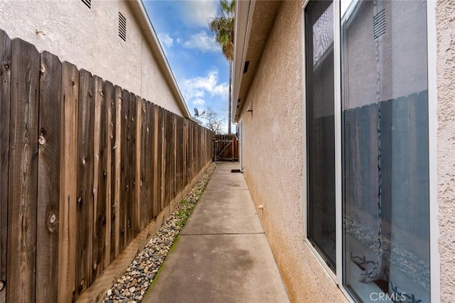 view of home's exterior with fence and stucco siding