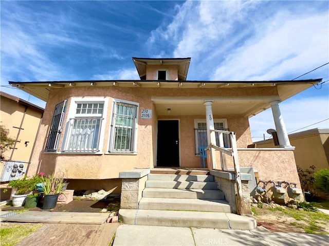 250 N Alvarado St Unit 3/4, Los Angeles, CA 90026 - view of front of property with stucco siding and a porch