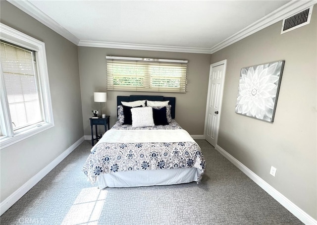 carpeted bedroom featuring ornamental molding, visible vents, and baseboards