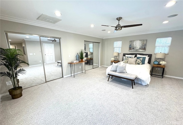 bedroom with crown molding, multiple windows, visible vents, and baseboards