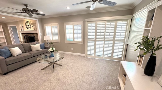 carpeted living area with a fireplace, recessed lighting, ornamental molding, ceiling fan, and baseboards