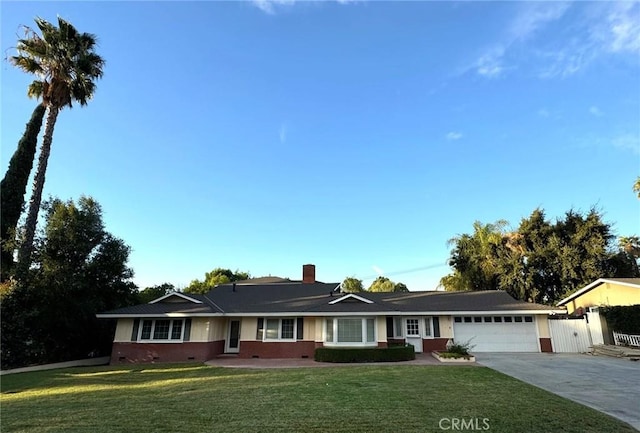 ranch-style house with concrete driveway, crawl space, an attached garage, fence, and a front yard