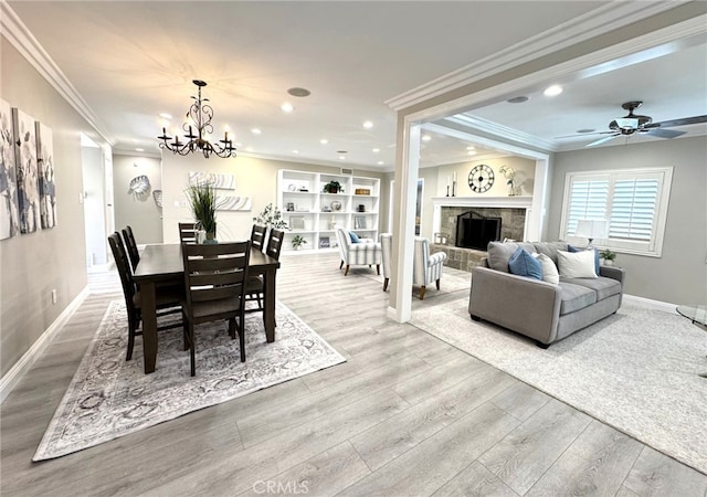 dining area featuring recessed lighting, a tiled fireplace, wood finished floors, and baseboards