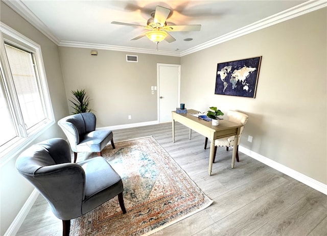 office with ornamental molding, wood finished floors, visible vents, and baseboards