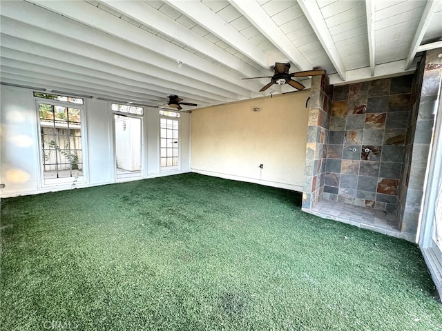 interior space with a healthy amount of sunlight, ceiling fan, and beam ceiling