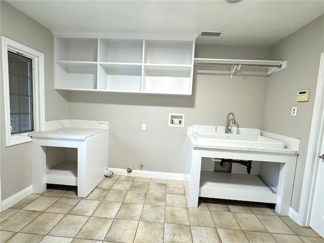 laundry room with laundry area, hookup for a washing machine, visible vents, and baseboards