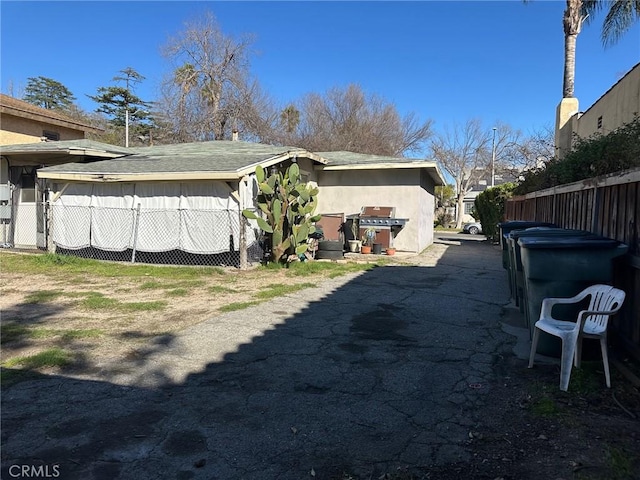 view of home's exterior with fence