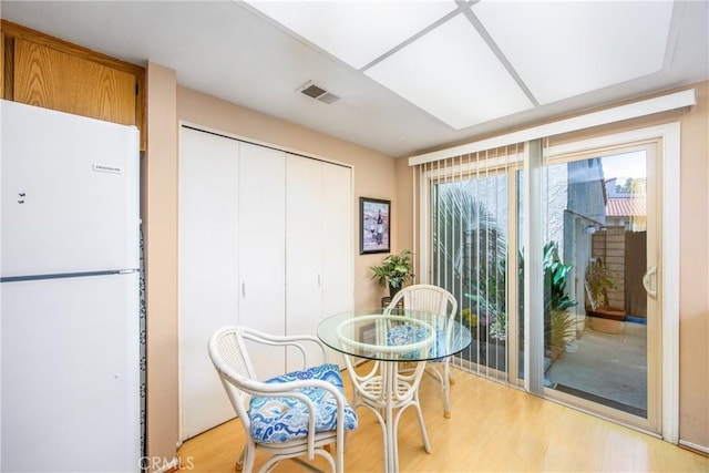 dining area featuring visible vents and wood finished floors