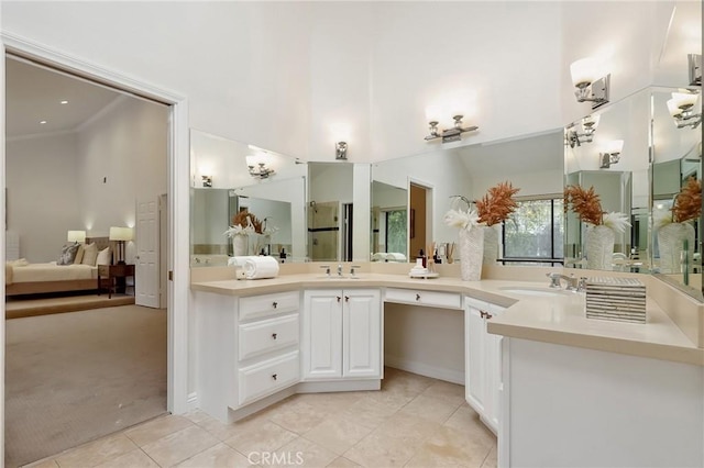 full bathroom with double vanity, a sink, ensuite bath, and tile patterned floors