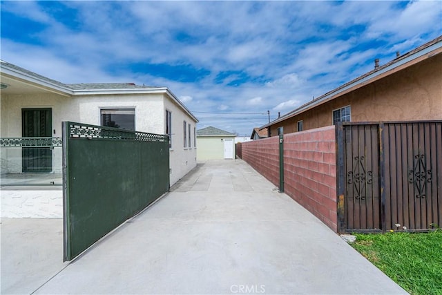view of home's exterior with stucco siding and fence