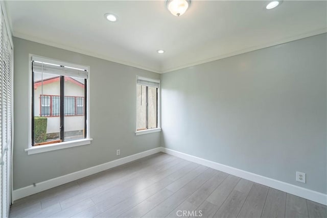 unfurnished room featuring baseboards, ornamental molding, wood finished floors, and recessed lighting