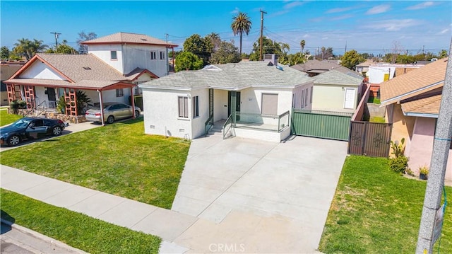 view of front of property with a residential view, stucco siding, fence, and a front lawn