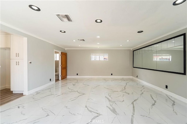 spare room with ornamental molding and visible vents