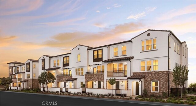 9831 La Serna Dr Unit 3, Whittier, CA 90605 - view of front of property featuring brick siding, a residential view, and stucco siding